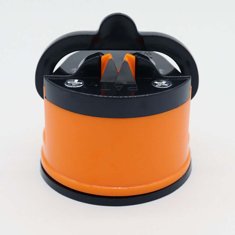 An orange and black knife sharpener with a suction base.