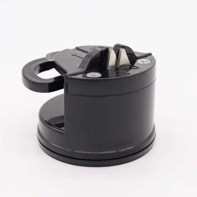 A black knife sharpener with a handle and suction base on a white background.